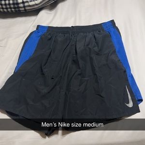 Men’s black Nike shorts with blue stripes on side, size medium